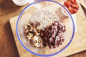 In a food processor, pulse the oats until you have mostly oat flour with some whole oats remaining, for texture. Transfer to the bowl. Put the black beans in the food processor and blend until mostly pureed with some whole beans remaining, also for texture. Transfer to the bowl.